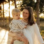 Caucasian woman holding a toddler