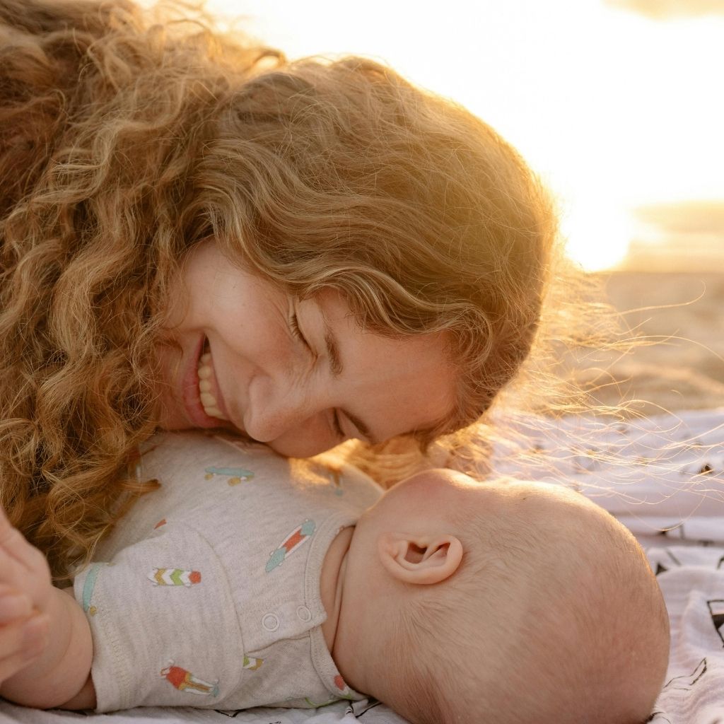 Mother lying face to face with her baby, sharing a close, affectionate moment