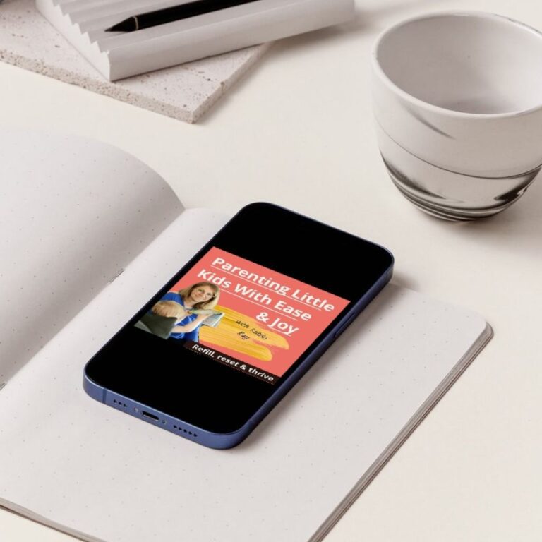 Iphone laying on a desk with a podcast cover